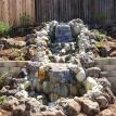 Jose's pondless waterfall starts 3' from the fence & drops down to ground level.